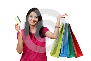 Young woman holding shopping bags and credit card