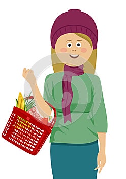 Young woman holding shopping basket filled with vegetables and fruits wearing knitted hat and scarf