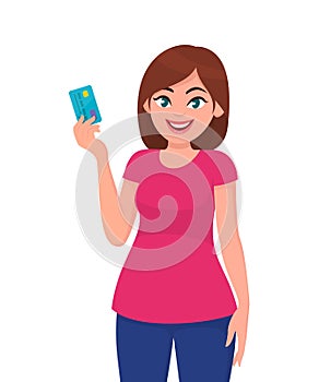 Young woman holding and showing credit/debit card. Girl showing a banking card. Business, finance, shopping, wireless payment.