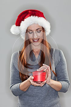 Young woman holding a small Christmas gift