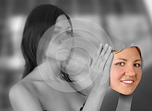 Young woman holding smiling face (digital composite)