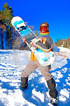 Young woman holding a snowboard