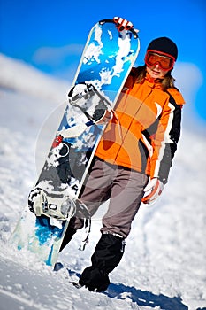 Young woman holding a snowboard