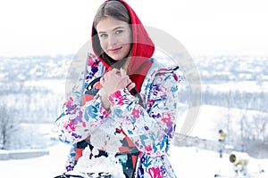 Young woman holding snowboard on her shoulders