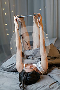 Young woman holding tablet with legs