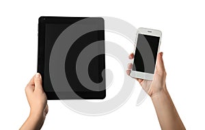 Young woman holding tablet PC and mobile phone on white background