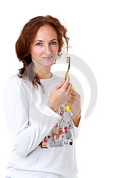 Young woman holding tooth brush and toothpaste