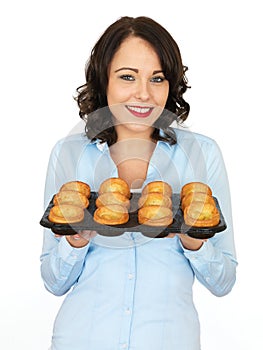 Young Woman Holding a Tray of Yorkshire Puddings