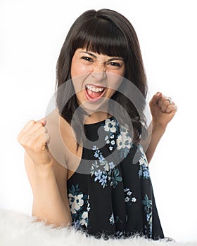 Young woman holding up clenched fists in victory