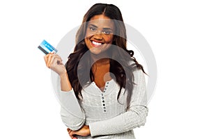 Young woman holding up a credit card