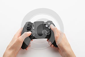 Young woman holding video game controller on white background