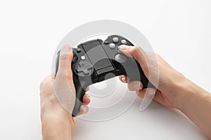 Young woman holding video game controller on white, closeup