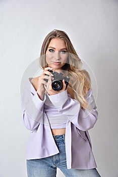 Young woman holding vintage camera in her hand