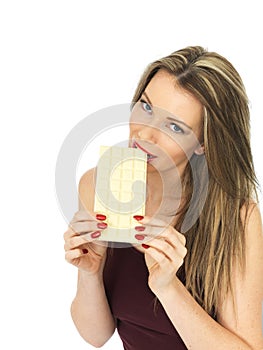 Young Woman Holding a White Chocolate Bar