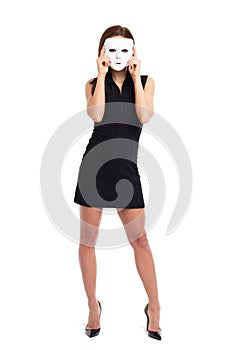 Young woman holding white mask in front of face full body isolated photo