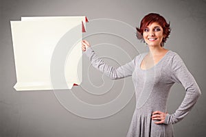 Young woman holding white origami paper copy space