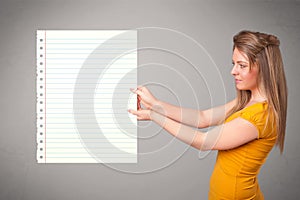 Young woman holding white paper copy space with diagonal lines