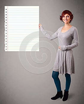 Young woman holding white paper copy space with diagonal lines