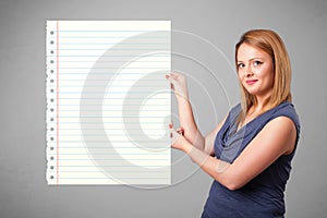 Young woman holding white paper copy space with diagonal lines