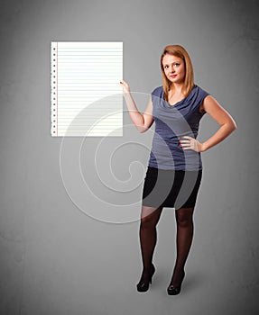 Young woman holding white paper copy space with diagonal lines