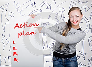 Young woman holding whiteboard with writing word: action plan. Technology, internet, business and marketing.