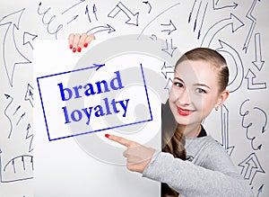 Young woman holding whiteboard with writing word: brand loyalty. Technology, internet, business and marketing.