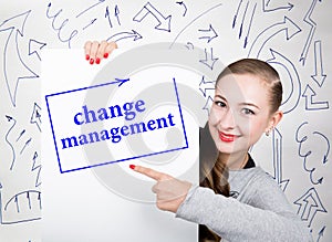 Young woman holding whiteboard with writing word: change management. Technology, internet, business and marketing.