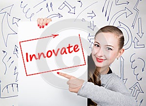 Young woman holding whiteboard with writing word: innovate. Technology, internet, business and marketing.