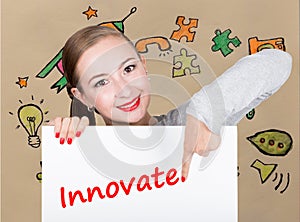 Young woman holding whiteboard with writing word: innovate. Technology, internet, business and marketing.