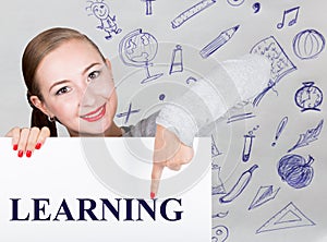 Young woman holding whiteboard with writing word: learning. Technology, internet, business and marketing.