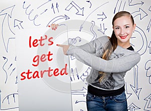 Young woman holding whiteboard with writing word: let`s get started. Technology, internet, business and marketing.