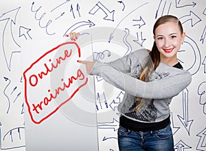 Young woman holding whiteboard with writing word: online training. Technology, internet, business and marketing.