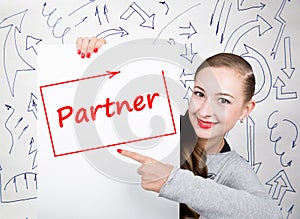Young woman holding whiteboard with writing word: partner. Technology, internet, business and marketing.
