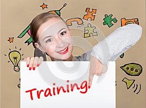 Young woman holding whiteboard with writing word: training. Technology, internet, business and marketing.