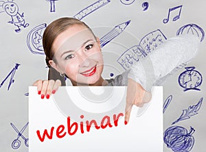 Young woman holding whiteboard with writing word: webinar. Technology, internet, business and marketing.