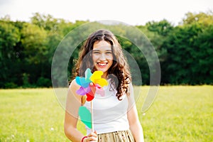 Young woman holding a windmill toy