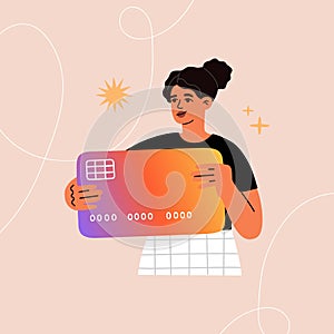 Young woman holds a big credit card. Personal finance concept. Online banking, digital money, cashless payment