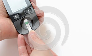 A young woman holds a glucometer in her hands and wants to do a blood test for sugar