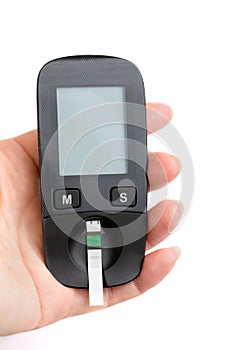 A young woman holds a glucometer in her hands and wants to do a blood test for sugar