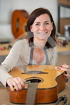 young woman holds guitar photo