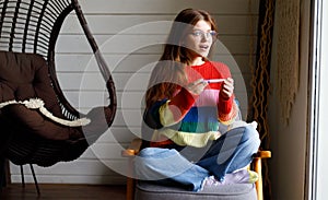 A young woman holds in her hands a positive test for pregnancy, maternity