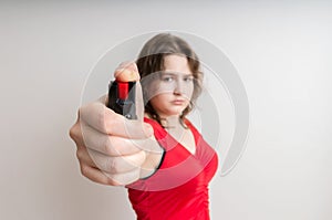 Young woman holds pepper spray in hand. Self defense concept