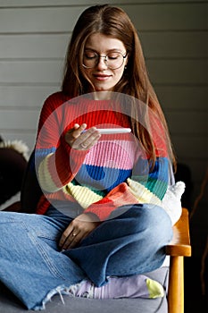 A young woman in a home interior holds a pregnancy test in her hands, positive