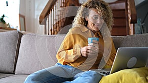 Young woman at home with laptop computer and connection - smart working free office home activity - modern people online job remot