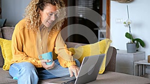 Young woman at home with laptop computer and connection - smart working free office home activity - modern people online job remot