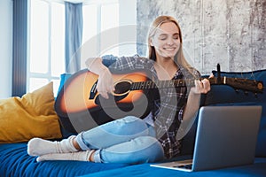 Young woman at home in the living room hobby video lessons