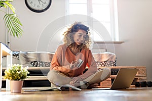 Young woman at home shopping online