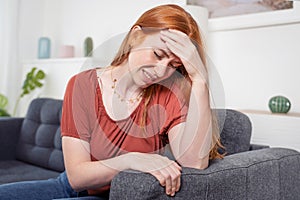 Young woman at home suffering severe chronic headache