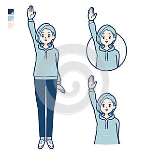 A Young woman in a hoodie with raise hand images