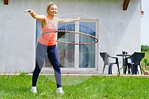Young woman with hoola hoop outdoors